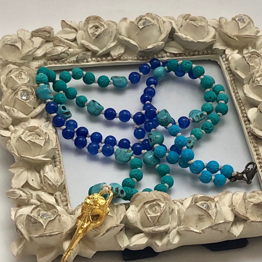 Turquoise beaded raven skull necklace